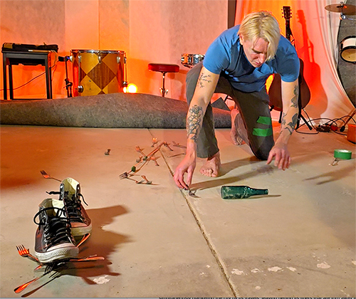 Photo of performance artist Scotch Wichmann performing ALIEN TUNING FORK in Ventura, CA, 2025